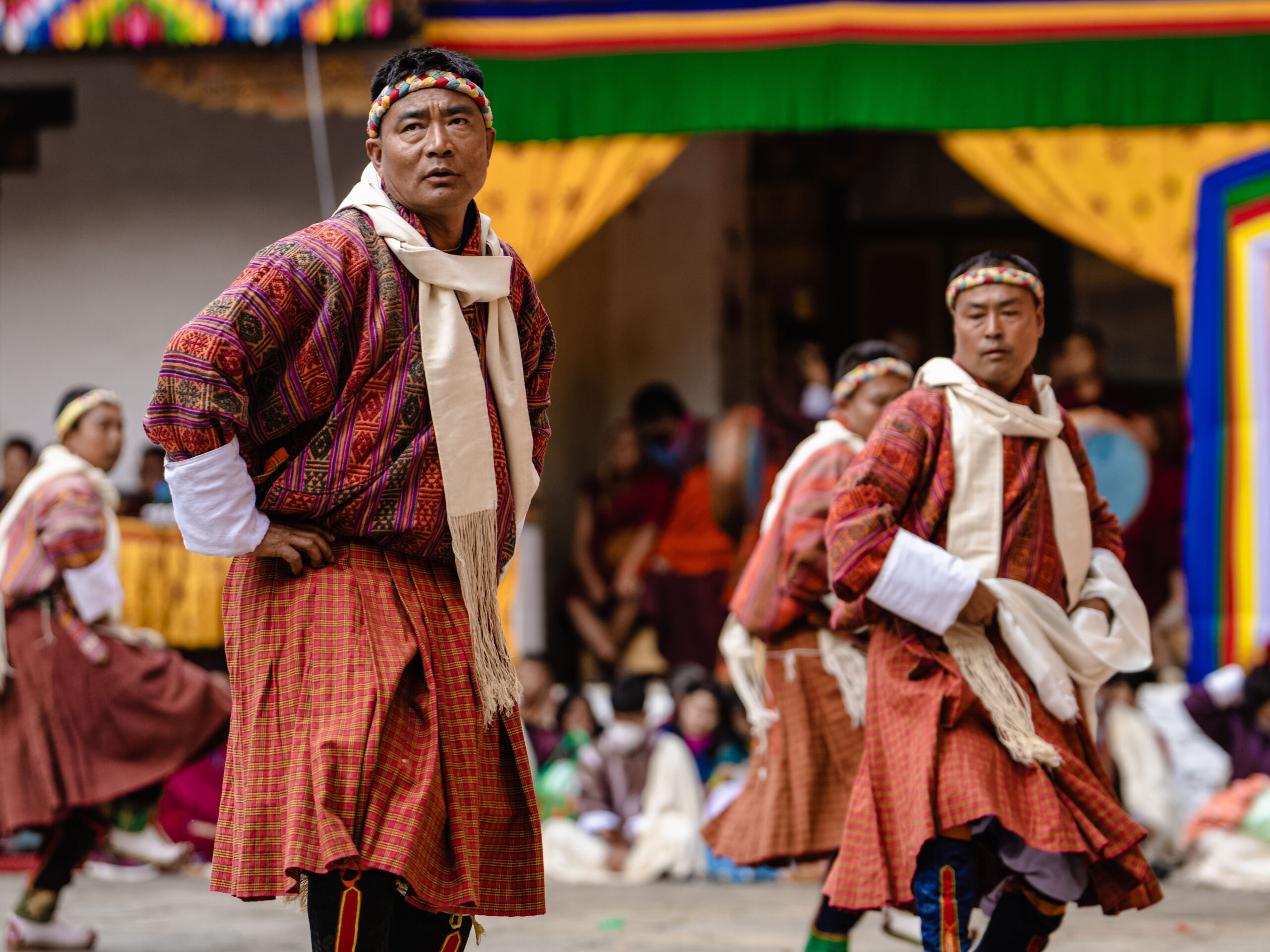 A Bhutanese dancer in traditional attire performing at Punakha's Tshechu festival