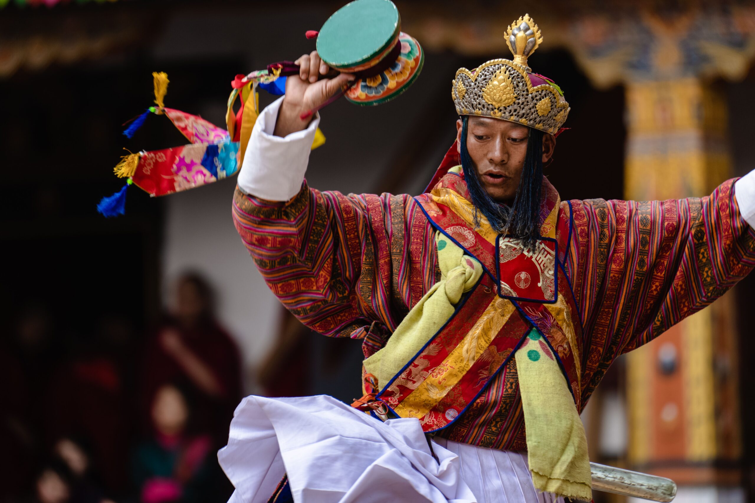 A Bhutanese dancer in traditional attire performing at Punakha's Tshechu festival